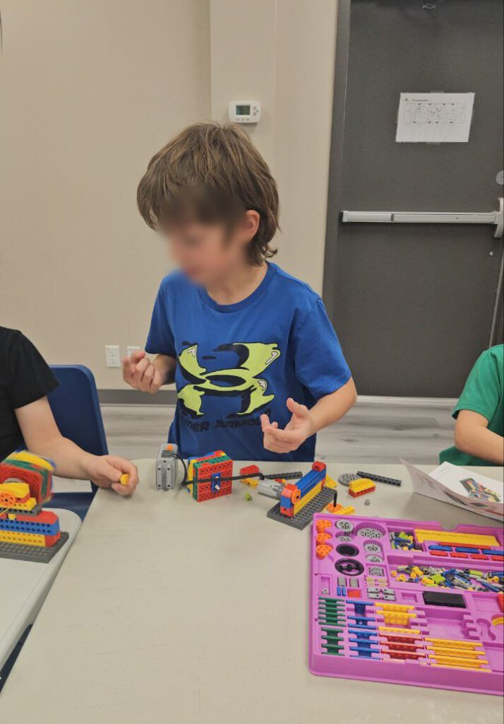 Kids building LEGO models in STEM after school program Calgary