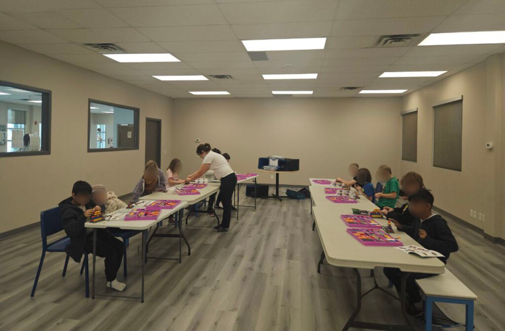 Instructor guiding kids in STEM activities Calgary